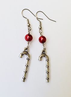 Elegant 3D candy cane charms that I paired with dark red pearl accents. These are a bit longer. Ear hooks are nickel free Candy Cane Earrings, Candy Earrings, Red Pearl, Holiday Candy, Earrings Christmas, Christmas Earrings, Ear Hook, Etsy Earrings Dangle, Christmas Candy