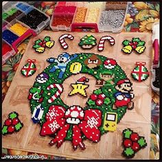 a wooden table topped with lots of different types of bead art work on top of it