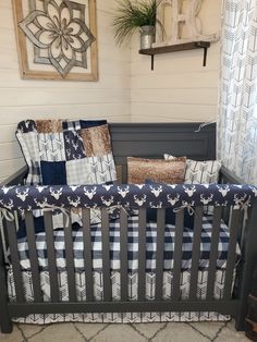 a baby crib with blue and white quilts on it