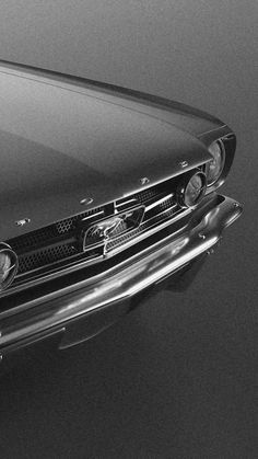 a black and white photo of an old car with the hood up on it's headlight