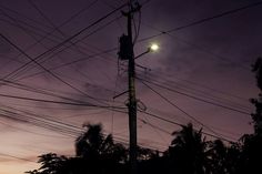 an electric pole and street light at night