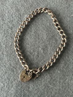 This is a vintage sterling silver charm bracelet with heart padlock clasp.   Clasps opens and shuts well.  The bracelet weighs 12.74 g and is 17cm in length approx. This is not a reproduction but an original bracelet. This is a vintage charm bracelet over 50 years old and in a used state so therefore minimal wear and scratches may been seen as silver is a soft metal. Please see my Etsy store here for more charms  https://www.etsy.com/uk/shop/SurreyVintageCharms?ref=profile_header  I post out my Vintage Silver Charm Bracelet, Bracelet Original, Bracelet With Heart, Heart Padlocks, Vintage Sterling Silver Charms, Vintage Charm Bracelet, Sterling Silver Charm Bracelet, Profile Header, Safety Chain