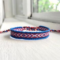 Handwoven Bracelet By Ecuadorian Artisans Using Cobalt Blue Base Color With Red, White & Neon Orange Soft Wool + Cotton Thread Ft. A Chevron & Rhombus Pattern. Easy To Tie-On Wrist With Twisted String Ends! : Fits 5" To 8 Inches (Measures 10 Inches Long) #: Handmade Bracelet Boho Fairy Grunge Jewelry Gypsy Stackable Bracelet Dainty Minimalist 90s Y2k 2000s Vintage Retro Jewelry Surfer Beach Coconut Girl Granola Girl Jewelry Bracelet Friendship Gift Cutecore Kawaii Horror Game Protagonist Fairyco Blue Woven Jewelry For Friendship, Adjustable Blue Woven Braided Bracelet, Adjustable Blue Braided Bracelet, Blue Woven Bracelets As Gifts, Blue Woven Bracelets As A Gift, Adjustable Blue Woven Bracelets, Adjustable Woven Blue Bracelets, Blue Woven Bracelet Jewelry, Adjustable Blue Woven Bracelet