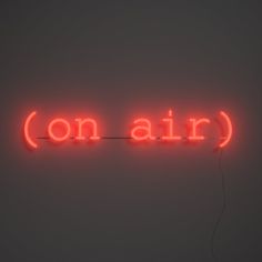 a red neon sign that reads on air