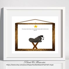 a white frame with a black dog laying on it's side and a star hanging from the top