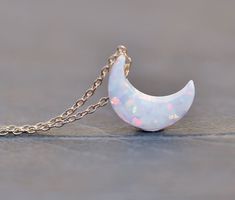 "A sweet new necklace made using a lab created opal moon charm. I love these little charms! They are crescent shaped and drilled near the top. It hangs from either 14K gold filled or Sterling silver chain (shown in gold filled in all photos above, but you can order in sterling silver at checkout). Moon measures 11mm (1/2\") and chain is a dainty 1 mm thick. Please choose desired color of moon and chain finish/length at checkout. Listing is for ONE necklace, in color and metal of choice. ** PLEAS Opal Moon Necklace, Opal White, Moon Charm, Moon Pendant, Moon Necklace, White Opal, Blue Opal, Sterling Silver Chains, Crescent