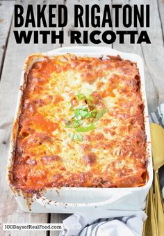 baked rigatoni with ricotta in a white casserole dish on a wooden table