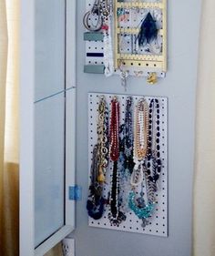 a wall mounted jewelry organizer in a closet