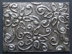 an intricately designed metal surface with swirls and circles on it's surface