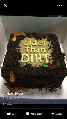 a cake that is in a box with the words older than dirt written on it