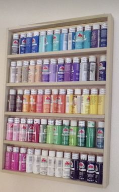 a shelf filled with lots of different types of paint