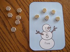 a snowman themed counting game with fives and sixs on the board next to it