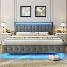 a bed that is in the middle of a room with blue light coming from it