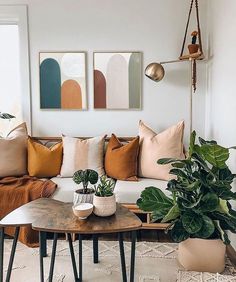 a living room filled with lots of furniture and plants on top of it's tables