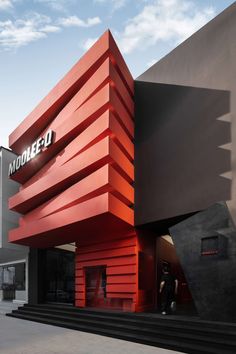 the modern building has red and black stripes on it