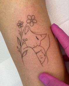 a woman's arm with a small tattoo design on the left side of her leg