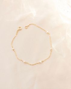 Pearl bracelet, Pearl charm bracelet, Dainty gold bracelet, Tiny pearl bracelet, Minimal bracelet, Delicate pearl bracelet, Simple bracelet --- Give your look a timeless, sophisticated edge with the Ella Bracelet! This classic beauty features a string of pearls that wrap all the way around, making it the perfect accessory for any bridal or special occasion. Feel your most elegant wearing a piece that'll never go out of style! Details: -Gold Filled, Sterling Silver -2mm pearl size  -Waterproof, T Dainty Gold Bracelets With Pearl Chain, Dainty Gold Pearl Bracelet With Pearl Charm, Dainty Pearl Chain Bracelet With Jubilee Style, Gold Pearl Charm Bracelet For Wedding, Delicate Pearl Chain Bracelet With Pearl Charm, Pearl Bracelet For Bridesmaid Gift, Delicate Beaded Bracelets With Pearl Charm For Bridesmaids, Delicate Gold Chain Bracelet With Pearl Charm, Delicate Gold Chain Bracelet With Pearls