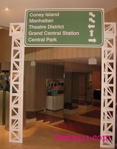 a green and white sign that is in the middle of a building with other signs on it