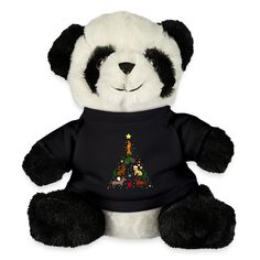 a black and white stuffed panda bear wearing a t - shirt with a christmas tree on it