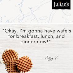 two waffles in the shape of hearts on top of a wooden table with a quote about breakfast