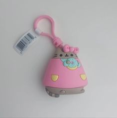 a pink hello kitty keychain with a tag attached to it's side