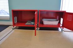 two red metal storage cabinets sitting on top of a carpeted floor