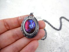 "This locket is exquisite! The focal point of this necklace is the glass cabochon which has been made in the style of a Mexican Opal also known as Dragon's Breath (made from glass not a gemstone). Each stone is handmade which means no two stones will be alike. With each slight turn, the colors shift from deep scarlet red to lightening strikes of blues! What is a Mexican Opal? Mexican Opal, also known as Dragon's Breath, is a collector's nickname for man-made stones that are made of glass and mix Multicolor Oxidized Jewelry As Gift, Multicolor Oxidized Finish Jewelry As Gift, Multicolor Necklace With Oxidized Finish For Gift, Mystical Multicolor Jewelry For Gift, Red Necklace With Oxidized Finish For Gift, Red Oxidized Finish Necklace For Gift, Iridescent Metal Necklace Gift, Mystical Oxidized Necklace For Gift, Mystical Oxidized Finish Necklace For Gift