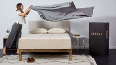 a woman unpacking a mattress in her bedroom