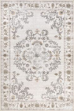 a rug with an ornate design on the front and back side, in grey tones