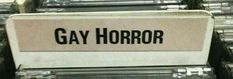 there is a sign that says gay horror on the back of some metal boxes in a store