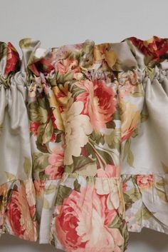 a close up of a flowered dress with ruffles on the sleeves and bottom