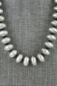 This sterling silver Navajo pearl necklace was made by Navajo silversmith Bryannen Halwood.Necklace: 17"Bead size: 5/8" x 1/2"Free shipping on all orders! We ship with USPS and always include tracking. All orders ship within a day of payment.Returns are accepted up to 30 days after you receive your order. Just send us a message. Our shop offers cash back or store credit. The item must be returned in new condition. Southwestern Silver Necklace With Large Beads, Hand-strung Silver Artisan Beaded Necklace, Southwestern Silver Beaded Necklace With Sterling Clasp, Southwestern Style Silver Single Strand Necklace, Artisan Silver Single Strand Beaded Necklace, Silver Single Strand Artisan Beaded Necklace, Artisan Silver Necklace Hand-strung, Southwestern Style Silver Necklace With Large Beads, Southwestern Silver Beaded Necklace With Large Beads