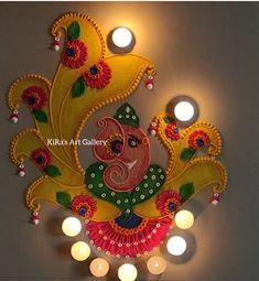 an intricately decorated wall hanging with candles and lights on the ceiling in front of it