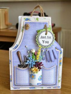 a card holder with flowers and gardening utensils in it that says just for you