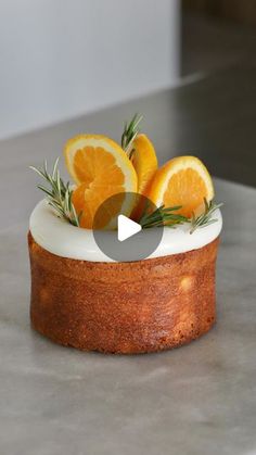 a cake with oranges and rosemary on top