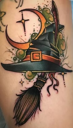 a tattoo with a witch hat and broom on it