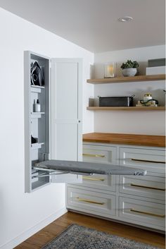 an open cabinet in the corner of a room