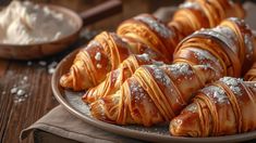 croissants on a plate with powdered sugar