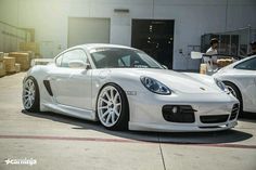 two white sports cars parked next to each other