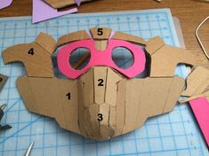 a paper mask made to look like a dog with pink goggles on it's face