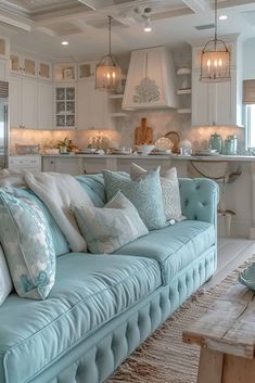 a living room filled with furniture and lots of pillows on top of a blue couch