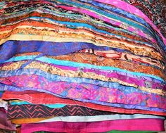 a pile of colorful cloths sitting on top of each other