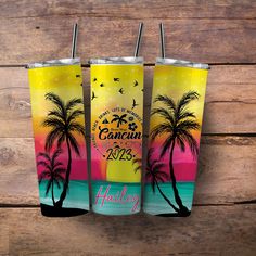 two colorful tumbles with palm trees and the words, happy new year on them