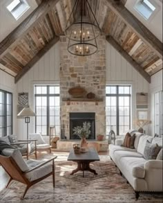 a living room filled with lots of furniture and a fire place in the middle of it