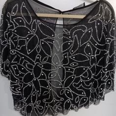 Dress Up Any Plain Dress, Jumpsuit Or Top With This Great Beaded And Pearl Cape. Lays Nicely Over The Shoulders And Hooks In The Back. Asymmetrical Design Hangs Nicely As The Beading Is Heavy. Sits Just Above The Elbows. Black Sheer Fabric Under The Beads. Measures 38" From Side To Side And 22" At The Longest Peak One The Right Side. I Have One Of These And Love Using It To Dress Up Any Garment. Nwot Chic Beaded Tops For Evening, Embellished Cocktail Tops For Summer, Embellished Black Tops For Cocktail, Black Sheer Fabric, Pearl Cape, Dress Jumpsuit, Plain Dress, Sheer Fabric, Asymmetrical Design