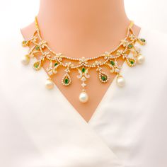 This exquisite 18k yellow gold necklace set, weighing 73.8 grams, features a luxurious design adorned with dazzling diamonds, pearls, and vibrant emeralds. The yellow gold finish enhances its elegant appeal, making it perfect for any special occasion. The set includes a necklace with a total diamond weight of 9.27 carats, featuring F-G color and VS quality diamonds. Complementing the diamonds are pearls weighing 42.14 carats and emeralds weighing 3.14 carats. The necklace has a length of 15 inch Elegant Gold Emerald Necklace With Cubic Zirconia, Elegant 22k Gold Emerald Necklace For Celebration, Elegant 22k Gold Emerald Necklace, Elegant Green Emerald Necklace In 22k Gold, Elegant 22k Gold Emerald Gemstone Necklace, Elegant 22k Gold Green Emerald Necklace, Luxury Yellow Gold Emerald Necklace For Wedding, Elegant Green Emerald 22k Gold Necklace, Elegant Yellow Gold Emerald Necklace For Festive Occasions