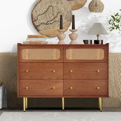 a wooden dresser sitting next to a wall with lamps on top of it and a lamp shade