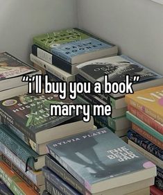 a stack of books with the words i'll buy you a book marry me