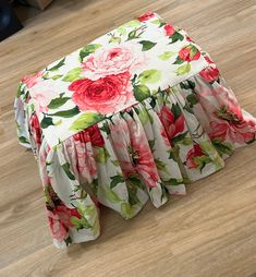 a flowered bed skirt is laying on the floor