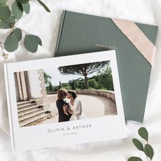 an open photo book next to a couple's wedding album